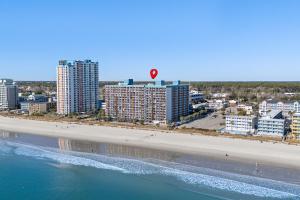 a kite is flying over a beach with buildings at Landmark Resort Ocean View Beach Pools Villa in Myrtle Beach