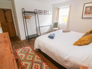 a bedroom with a large bed and a window at Widgeons Keel in Falmouth
