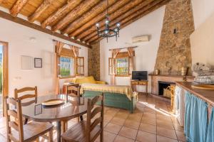 a living room with a table and a couch at Cortijo El Plantío Castril in Castril