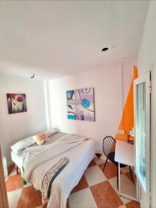 a white bedroom with a bed and a desk at Ikigai House in Seville +83 photos