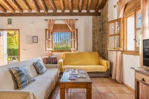 a living room with a couch and a table at Cortijo El Plantío Castril in Castril