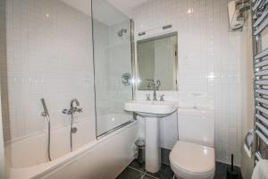 a bathroom with a toilet and a sink and a shower at 3 Combehaven in Salcombe +14 photos