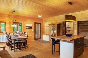 a kitchen and dining room with a table and chairs at Penthouse im Bauernhaus in Kötschach