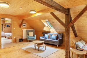 a living room with a couch and a table at Penthouse im Bauernhaus in Kötschach