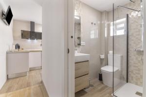 a bathroom with a shower and a toilet and a sink at Encanto Costero in Ayamonte +13 photos