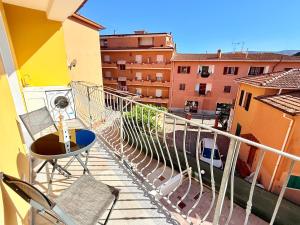 a balcony with chairs and a view of buildings at Appartamento Mavi in Porto Azzurro