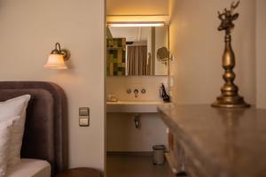 a bathroom with a sink and a mirror at Hotel By Atelier in Nijmegen +47 photos