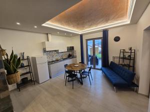 a living room with a blue couch and a table at Casa Mia Holiday House in Pianillo