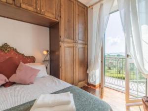 a bedroom with a bed and a large window at Il Giardino Etrusco Bolsena in Bolsena +12 photos