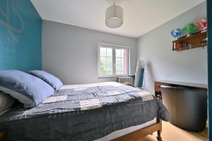 a bedroom with a bed and a desk and a window at Pays De L'ours - Pyrénées in Melles