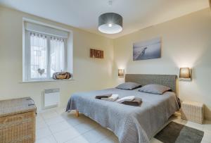 a bedroom with a bed with two towels on it at Grain de sable in Saint-Benoît-des-Ondes