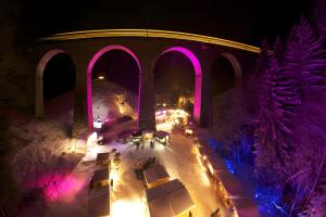 an overhead view of a winter night with pink lights at Ferienhaus Völkle in Hinterzarten +44 photos