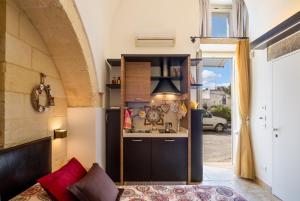 a kitchen with a sink in a room with a window at Monolocale Delux Alithia in Muro Leccese +12 photos