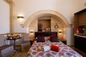 a bedroom with a large bed with an archway at Monolocale Delux Alithia in Muro Leccese