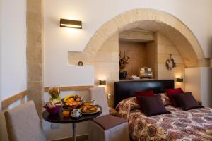a hotel room with a bed and a table with fruit on it at Monolocale Delux Alithia in Muro Leccese