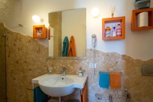 a bathroom with a sink and a mirror at Monolocale Delux Alithia in Muro Leccese