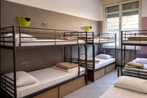 a group of bunk beds in a room at Koala Hostel in Milan