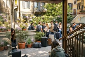 a group of people standing around with their luggage at Koala Hostel in Milan