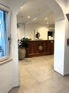 an entrance to a lobby with a counter and a room at Hotel Dania in Sorrento +95 photos