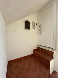 a room with a staircase with a clock on the wall at Casa Vacanze Flora in Peschici