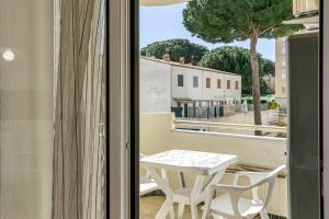 a small table and chairs on a balcony with a view at San Enrique in L'Escala
