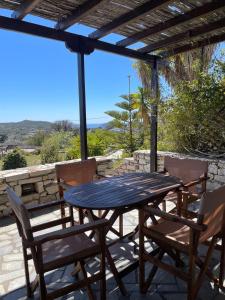 a table and chairs on a patio with a view at Kythiris Studios in Kálamos Kythira