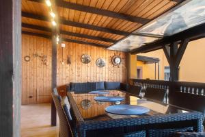 a restaurant with tables and chairs and wooden walls at Gemütliche Ferienhaus am Main in Gemünden