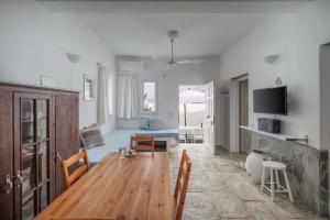 a living room with a wooden table and a couch at House Avlomonas in Livadi
