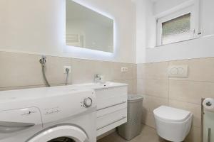 a white bathroom with a sink and a toilet at Ferienwohnung Auszeit in Calw +13 photos