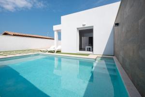 a villa with a swimming pool and a house at Casa El Palmar 2 in Vejer de la Frontera