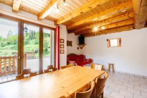 a dining room with a wooden table and chairs at Primevère in Valloire +14 photos