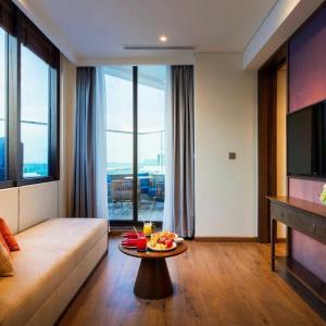 a living room with a couch and a table at Apec Beach Luxury Mũi Né in Mui Ne