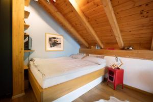 a bedroom with a bed in a room with wooden ceilings at Ferienhaus Chalet Montfort in Sonthofen
