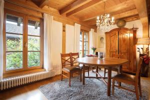 a dining room with a wooden table and chairs at Ferienhaus Chalet Montfort in Sonthofen