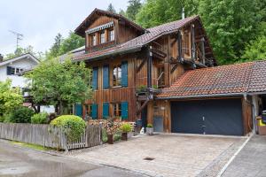 a large wooden house with a garage at Ferienhaus Chalet Montfort in Sonthofen