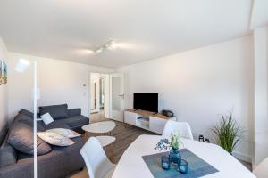 a living room with a couch and a table at Strandnahe Fewo 1 in Dierhagen