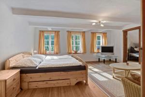 a bedroom with a bed and a living room at Hof Hohe Eichen in Göhrde