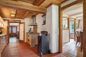 a large kitchen with wooden ceilings and wooden floors at Hof Hohe Eichen in Göhrde