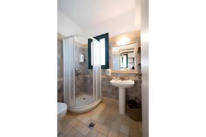 a bathroom with a shower and a sink at Kythiris Studios in Kálamos Kythira
