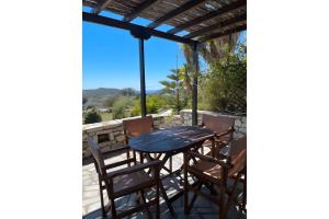a table and chairs on a patio with a view at Kythiris Studios in Kálamos Kythira +35 photos