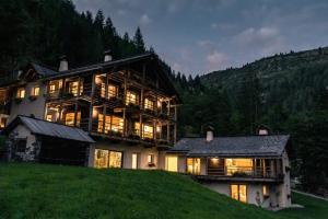 a large house sitting on top of a hill at Dolomites Cesa Del Louf Superior in Arabba
