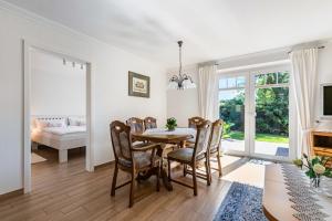 a dining room with a table and chairs at Ferienhaus Christine in Breklum