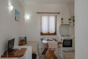 a small living room with a table and a kitchen at Maria's Village Suite in Kampos Paros +26 photos