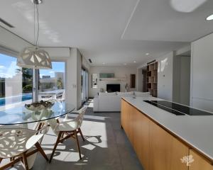 a kitchen and living room with a glass table and chairs at Tipuana 7 in Orihuela
