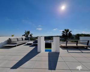 a patio with couches and tables on a roof at Tipuana 7 in Orihuela