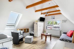 a living room with a couch and a table at Huus achtern Diek - Ferienwohnung 5 in Nordstrand