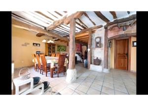 a living room with a table and chairs at Casa Llano in Llano de Bureba +12 photos