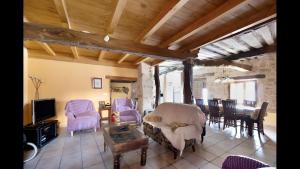 a living room with purple chairs and a table at Casa Llano in Llano de Bureba