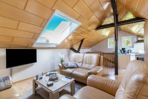 a living room with a vaulted ceiling with a large window at Alte Schmiede in Kuden