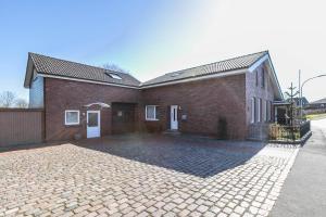a brick house with a driveway in front of it at Alte Schmiede in Kuden